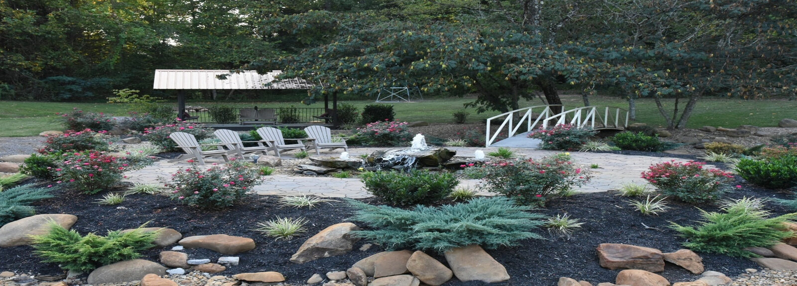 Landscaped picnic area with Adirondack chairs at The Summit on Bluff Mountain