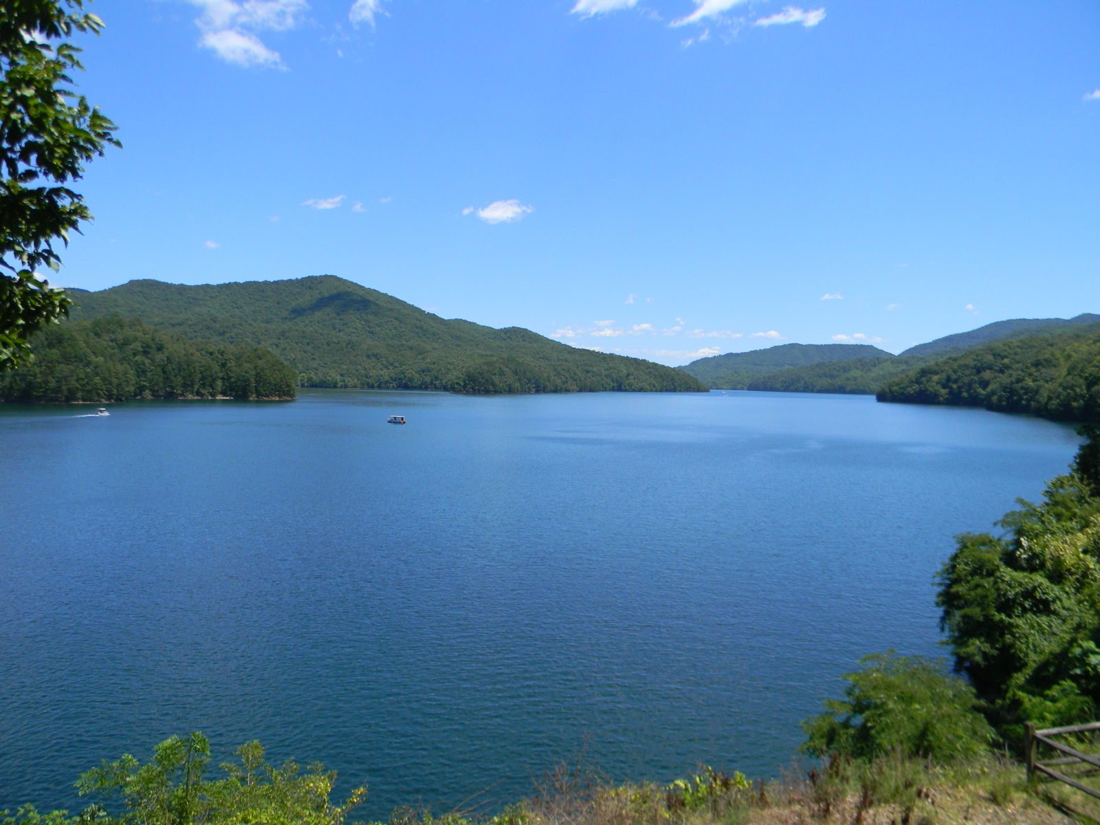 Blue waters of Fontana Lake framed by forested Smoky Mountain ridges on a clear day