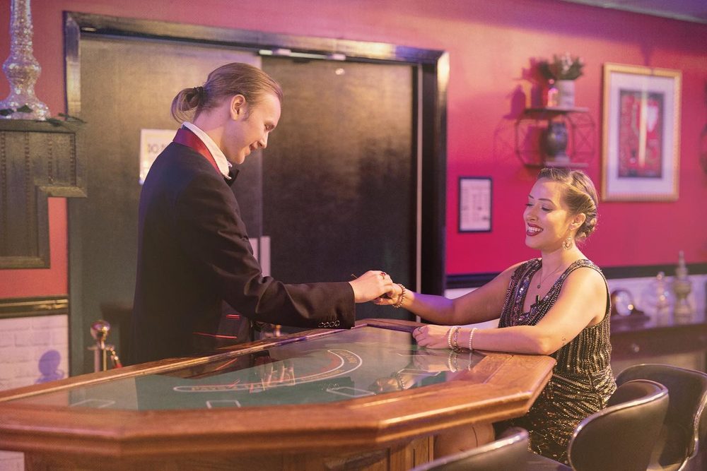 Costumed cast members performing a 1920s-style scene at a bar during Riga-Tony's murder mystery dinner show
