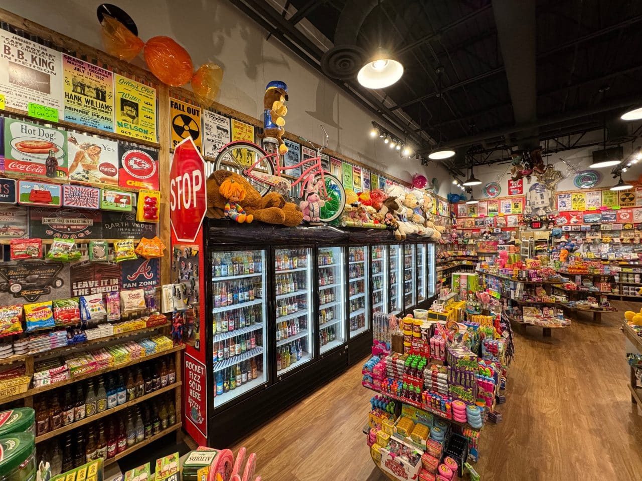 Candy shelves, retro signs and drink coolers inside a Rocket Fizz candy and soda shop