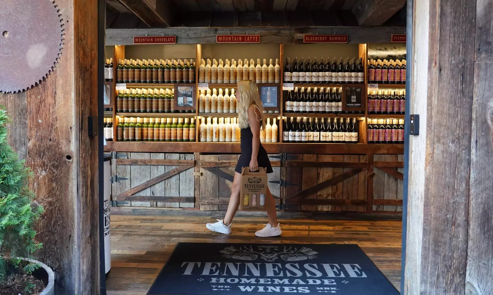 Barn-wood entrance to the Tennessee Homemade Wines tasting room with wine shelves behind